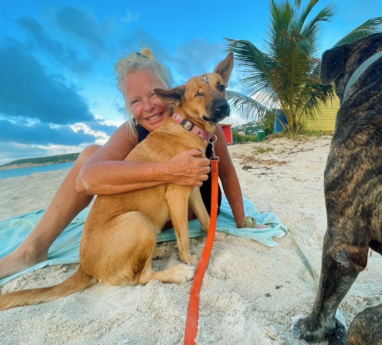 MacKenzie Hodge on Dickenson bay with Rescue Dog from Antigua